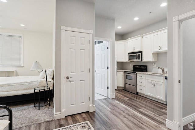 2718 N 2125 E, Layton, UT 84040 - kitchen featuring stainless steel appliances, dark wood-style floors, white cabinets, and recessed lighting