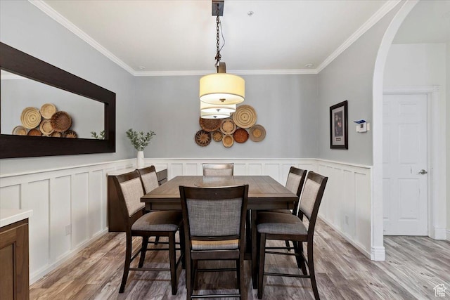 2718 N 2125 E, Layton, UT 84040 - dining space featuring light wood-style floors, ornamental molding, arched walkways, a wainscoted wall, and a decorative wall