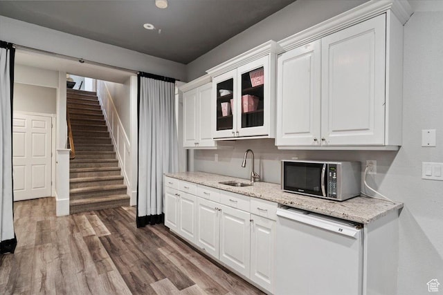 2718 N 2125 E, Layton, UT 84040 - kitchen with dishwasher, white cabinets, wood finished floors, glass insert cabinets, and light stone counters