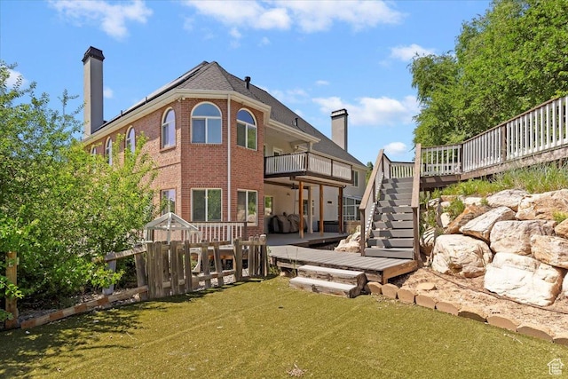 2718 N 2125 E, Layton, UT 84040 - back of property with stairway, brick siding, a chimney, a wooden deck, and a lawn