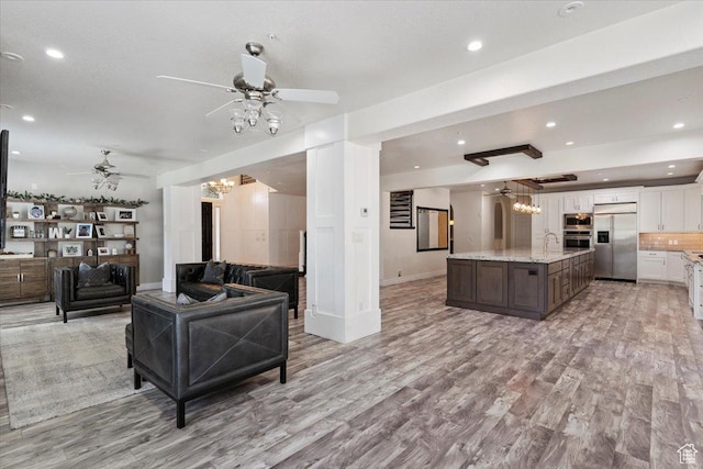 2718 N 2125 E, Layton, UT 84040 - living area with a ceiling fan, light wood finished floors, recessed lighting, and a chandelier