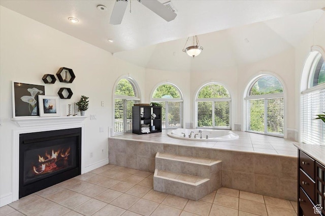 2718 N 2125 E, Layton, UT 84040 - bathroom featuring a garden tub, healthy amount of natural light, tile patterned floors, a glass covered fireplace, and a towering ceiling