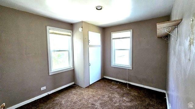 231 E 200 N, Vernal, UT 84078 - unfurnished bedroom featuring multiple windows and carpet flooring