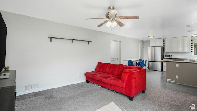 985 Jackson Ave, Ogden, UT 84404 - carpeted living area with a ceiling fan and tile patterned floors