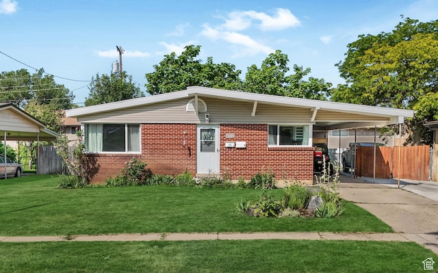 985 Jackson Ave, Ogden, UT 84404 - view of front of house with brick siding, a carport, and concrete driveway