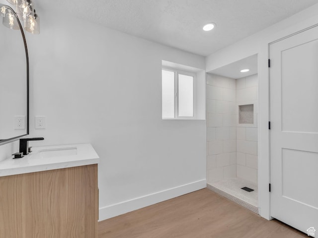 6685 S 3380 W, West Jordan, UT 84084 - full bath featuring vanity, a tile shower, wood finished floors, and a textured ceiling