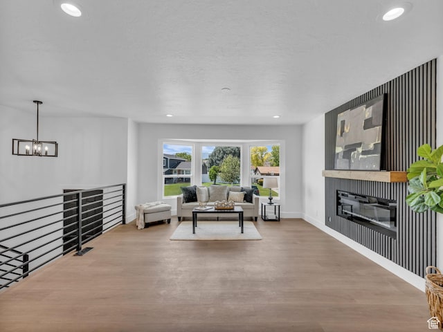 6685 S 3380 W, West Jordan, UT 84084 - living area featuring wood finished floors, a chandelier, recessed lighting, and a glass covered fireplace