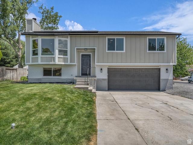 6685 S 3380 W, West Jordan, UT 84084 - split foyer home with a garage, brick siding, solar panels, and a chimney