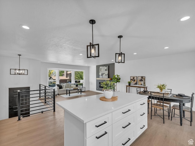6685 S 3380 W, West Jordan, UT 84084 - kitchen featuring light wood finished floors, recessed lighting, light countertops, and white cabinets