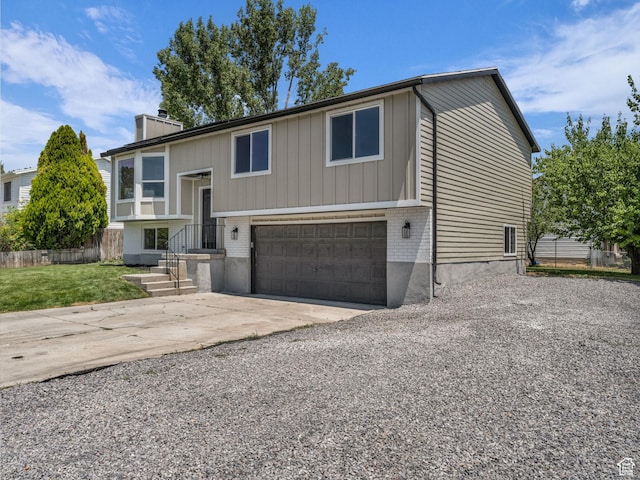 6685 S 3380 W, West Jordan, UT 84084 - raised ranch with driveway, a chimney, a garage, and brick siding