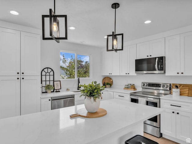 6685 S 3380 W, West Jordan, UT 84084 - kitchen featuring stainless steel appliances, recessed lighting, white cabinets, and hanging light fixtures