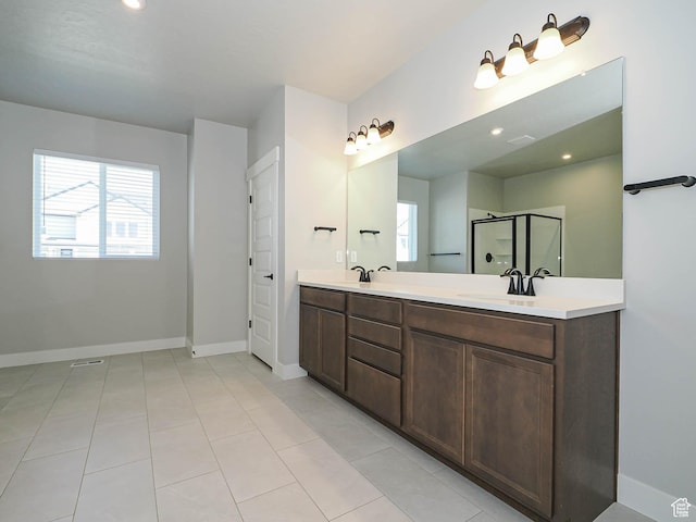 928 E Blackfeet Dr, Eagle Mountain, UT 84005 - bathroom with plenty of natural light, double vanity, a shower with door, tile patterned floors, and recessed lighting