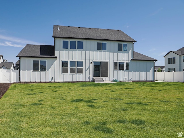 928 E Blackfeet Dr, Eagle Mountain, UT 84005 - back of property with board and batten siding, a fenced backyard, and entry steps