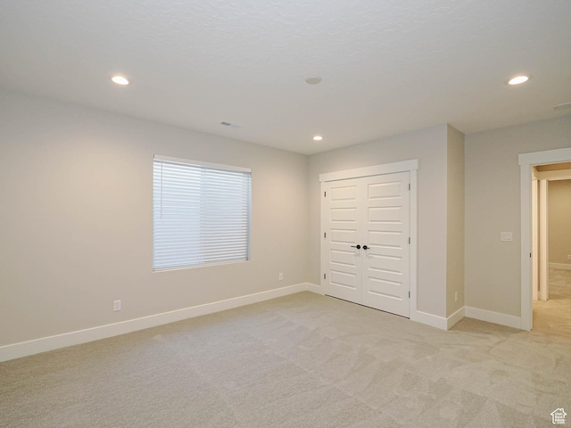 928 E Blackfeet Dr, Eagle Mountain, UT 84005 - unfurnished bedroom featuring recessed lighting, light colored carpet, and a closet