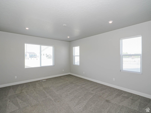 928 E Blackfeet Dr, Eagle Mountain, UT 84005 - spare room with dark carpet and recessed lighting