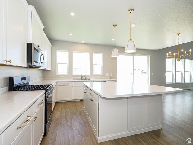 928 E Blackfeet Dr, Eagle Mountain, UT 84005 - kitchen featuring appliances with stainless steel finishes, a kitchen island, a chandelier, white cabinets, and recessed lighting
