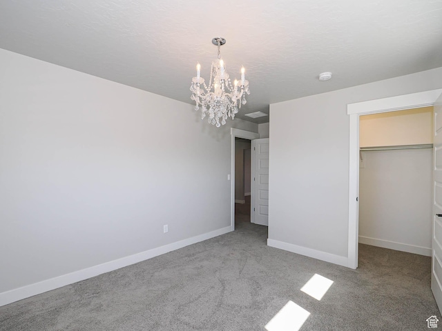 928 E Blackfeet Dr, Eagle Mountain, UT 84005 - unfurnished bedroom with a chandelier, carpet, and a walk in closet