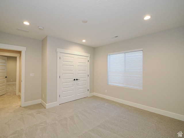 928 E Blackfeet Dr, Eagle Mountain, UT 84005 - unfurnished bedroom featuring light colored carpet, recessed lighting, and a closet