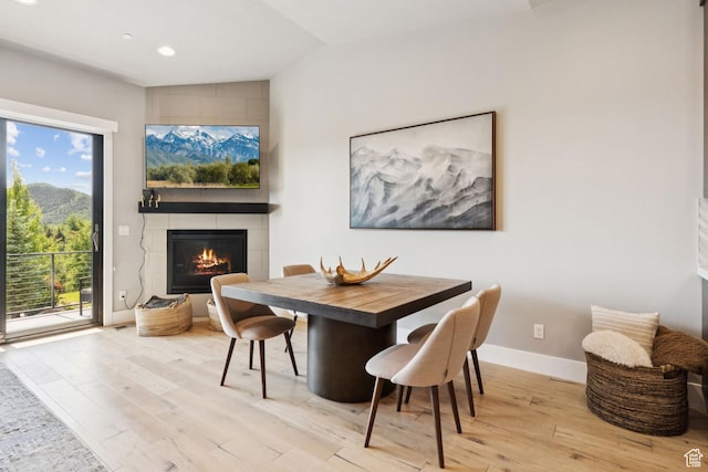 4313 Holly Frost Ct, Park City, UT 84098 - dining area featuring lofted ceiling, wood finished floors, a large fireplace, and recessed lighting