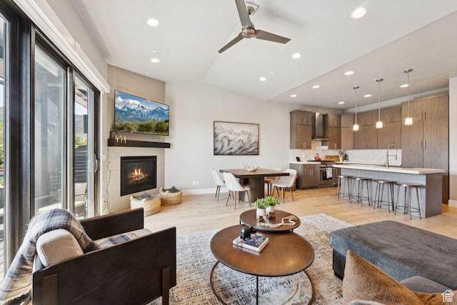 4313 Holly Frost Ct, Park City, UT 84098 - living room featuring a glass covered fireplace, recessed lighting, light wood-style flooring, ceiling fan, and vaulted ceiling