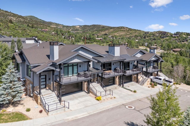 4313 Holly Frost Ct, Park City, UT 84098 - modern home featuring a chimney, a garage, concrete driveway, stone siding, and a shingled roof