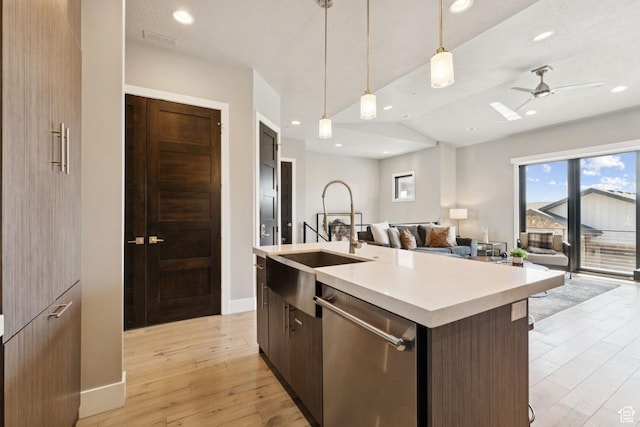 4313 Holly Frost Ct, Park City, UT 84098 - kitchen with dishwasher, open floor plan, light countertops, an island with sink, and light wood-type flooring