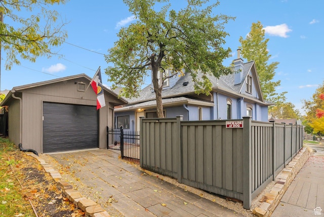 853 E Second Ave N, Salt Lake City, UT 84103 - view of front of property featuring a fenced front yard, a shingled roof, an outbuilding, and a chimney