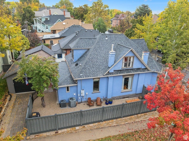 853 E Second Ave N, Salt Lake City, UT 84103 - rear view of property featuring a shingled roof, a fenced backyard, a chimney, a residential view, and brick siding