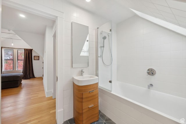853 E Second Ave N, Salt Lake City, UT 84103 - full bathroom with vanity, shower / bathtub combination, vaulted ceiling, and wood finished floors