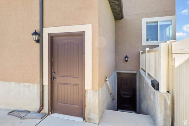 6082 W Cedar Fork Dr S, West Jordan, UT 84081 - doorway to property featuring stucco siding