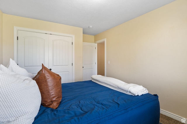 6082 W Cedar Fork Dr S, West Jordan, UT 84081 - carpeted bedroom featuring baseboards and a closet