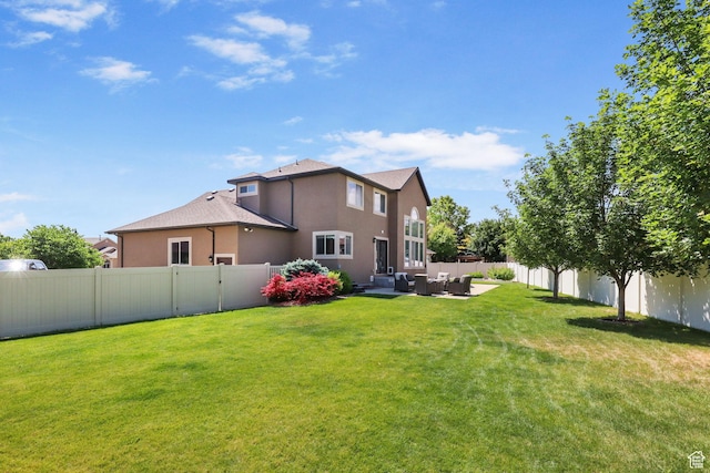 6082 W Cedar Fork Dr S, West Jordan, UT 84081 - rear view of property featuring an outdoor living space, stucco siding, and a fenced backyard