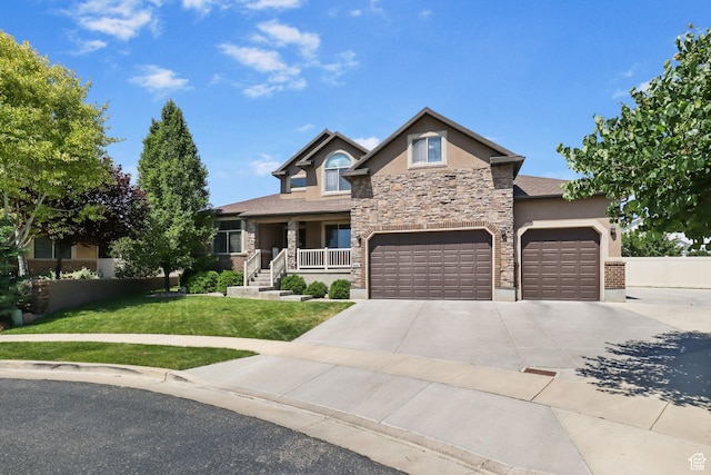 6082 W Cedar Fork Dr S, West Jordan, UT 84081 - view of front facade featuring stucco siding, stone siding, driveway, covered porch, and a garage