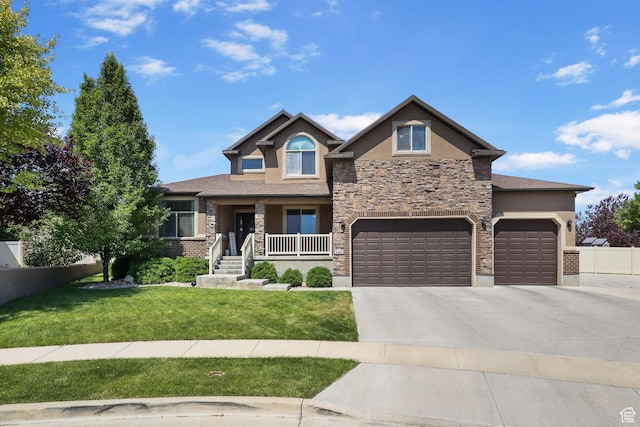 6082 W Cedar Fork Dr S, West Jordan, UT 84081 - view of front of property with stucco siding, driveway, stone siding, a front yard, and covered porch