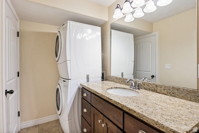 6082 W Cedar Fork Dr S, West Jordan, UT 84081 - bathroom featuring stacked washing machine and dryer, vanity, tile patterned flooring, and a chandelier