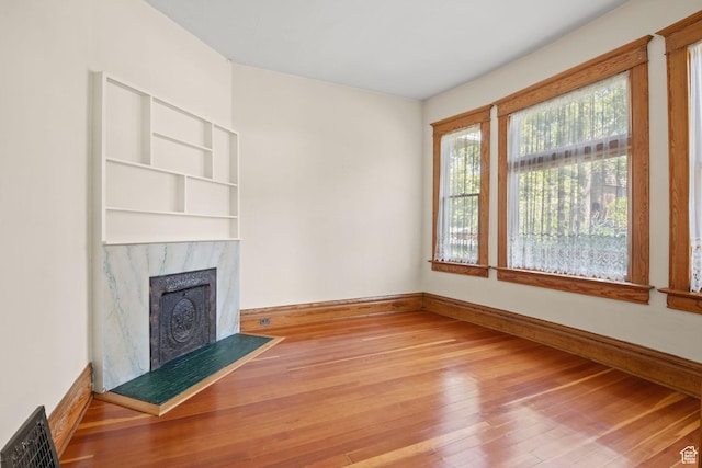 320 E 3rd Ave, Salt Lake City, UT 84103 - unfurnished living room featuring hardwood / wood-style floors and a high end fireplace