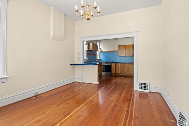 320 E 3rd Ave, Salt Lake City, UT 84103 - unfurnished dining area featuring a chandelier and hardwood / wood-style floors