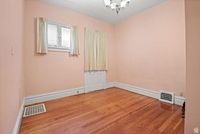 320 E 3rd Ave, Salt Lake City, UT 84103 - spare room with a chandelier and hardwood / wood-style flooring