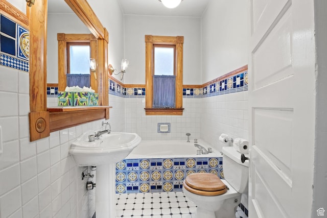 320 E 3rd Ave, Salt Lake City, UT 84103 - bathroom featuring tile walls, a garden tub, and a wainscoted wall