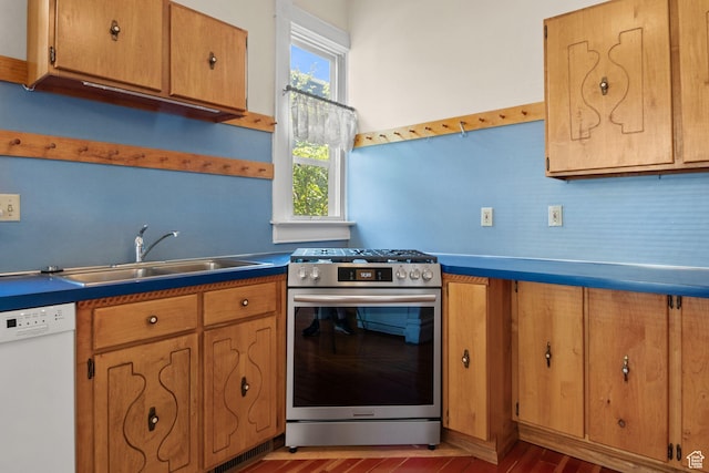 320 E 3rd Ave, Salt Lake City, UT 84103 - kitchen with white dishwasher, stainless steel range with gas stovetop, decorative backsplash, brown cabinetry, and wood finished floors