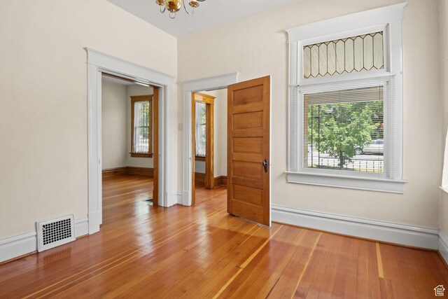 320 E 3rd Ave, Salt Lake City, UT 84103 - spare room featuring a chandelier and wood finished floors