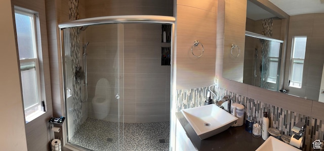 1133 E Sherman Ave S, Salt Lake City, UT 84105 - full bathroom with a shower stall, tile walls, vanity, and tasteful backsplash