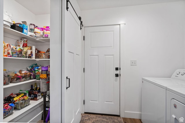 2418 E Quaking Aspen Ln, Eagle Mountain, UT 84005 - washroom featuring a barn door, independent washer and dryer, and wood finished floors