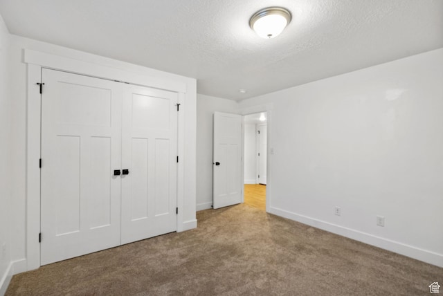 2418 E Quaking Aspen Ln, Eagle Mountain, UT 84005 - unfurnished bedroom featuring carpet, a textured ceiling, and a closet