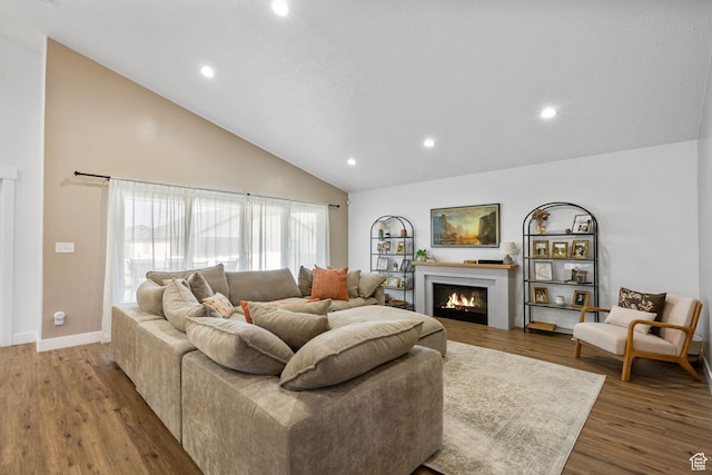 2418 E Quaking Aspen Ln, Eagle Mountain, UT 84005 - living room with wood finished floors, recessed lighting, a lit fireplace, and high vaulted ceiling