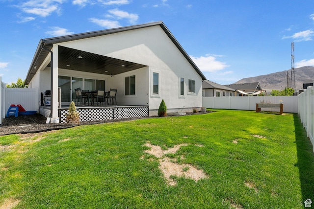 2418 E Quaking Aspen Ln, Eagle Mountain, UT 84005 - rear view of house with a fenced backyard, a mountain view, and stucco siding