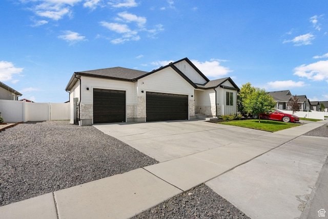2418 E Quaking Aspen Ln, Eagle Mountain, UT 84005 - view of front of home featuring an attached garage, concrete driveway, and stone siding