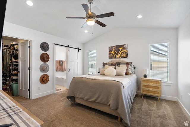 2418 E Quaking Aspen Ln, Eagle Mountain, UT 84005 - bedroom with a barn door, carpet, a spacious closet, lofted ceiling, and multiple windows