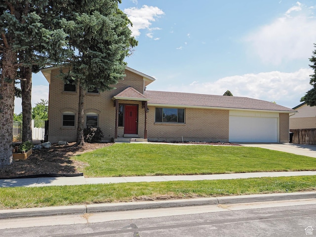 2333 W Ledgewood Dr, Taylorsville, UT 84129 - tri-level home featuring brick siding, concrete driveway, and a garage