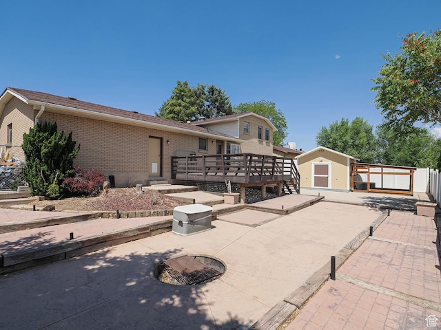 2333 W Ledgewood Dr, Taylorsville, UT 84129 - view of patio with a storage shed, a deck, and an outdoor fire pit